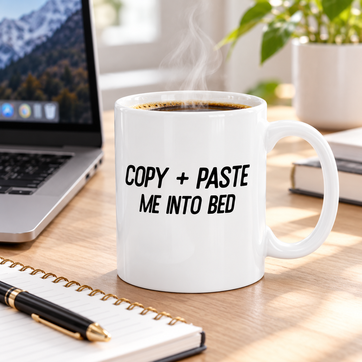 Copy and Paste Me Into Bed ceramic mug on an office desk beside laptop and notebook