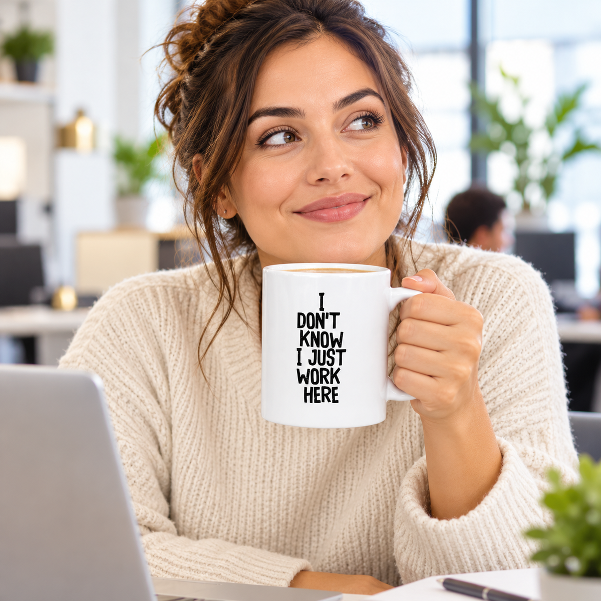 Woman holding I Don’t Know I Just Work Here ceramic mug at work